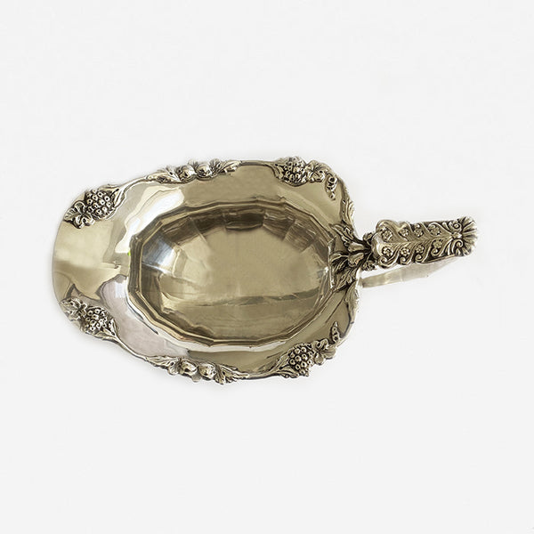 an ornate secondhand milk jug made in solid silver