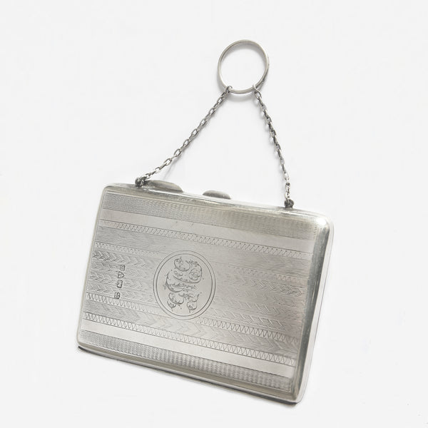 a silver finger purse with engine turned pattern and initials with pencil dated 1904