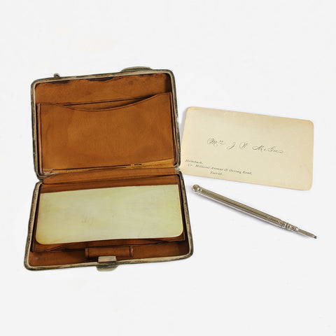 an antique finger purse in silver with pencil and card dated 1904