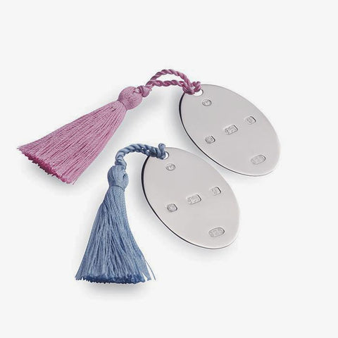 an oval disc with a hallmark all in sterling silver and pink or blue tassels bookmark