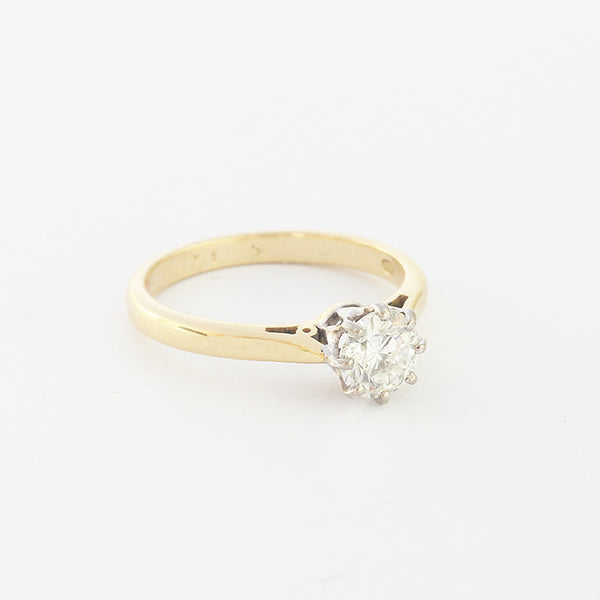 a modern brilliant cut diamond solitaire ring with claws and gold band