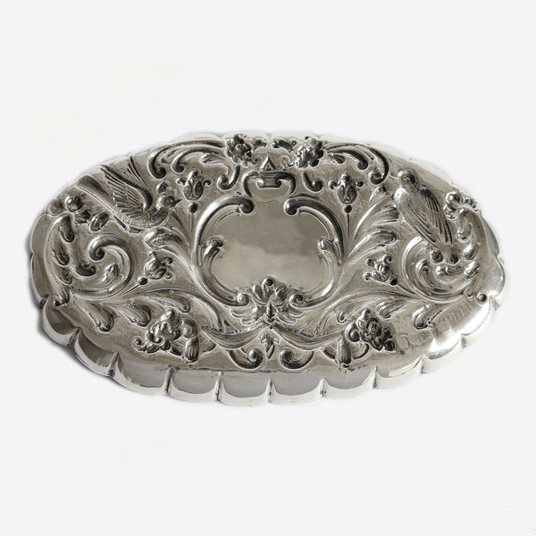 a beautiful set of silver oval embossed trays with birds and flowers