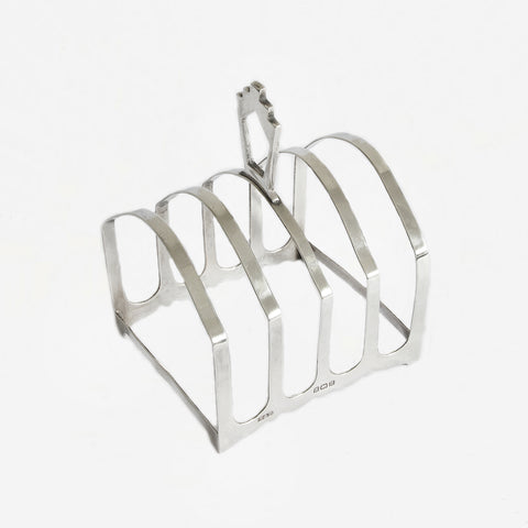 a silver toast rack with 5 arched bars dated 1932