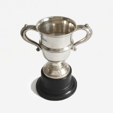 a silver vintage trophy cup with hallmark for 1930 and plinth
