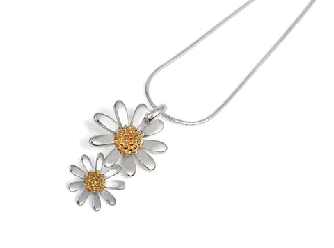 a silver double daisy pendant with snake chain