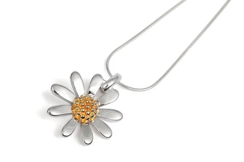 a silver daisy pendant with snake chain