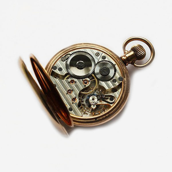 a preowned gold plate pocket watch open faced by kendal and dent with 19 jewels 