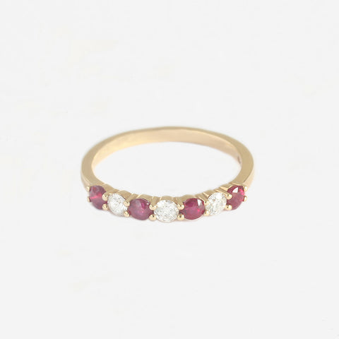 a yellow gold ruby diamond half eternity ring