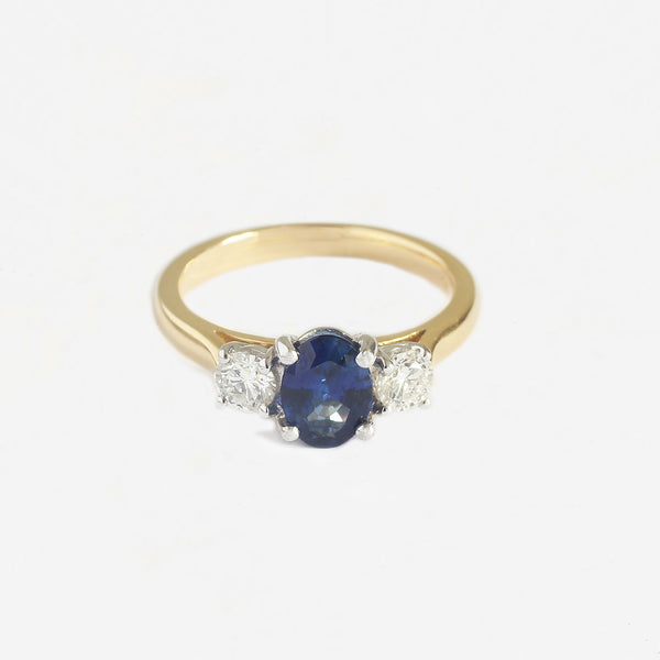 a yellow and white gold oval sapphire and diamond 3 stone claw set ring