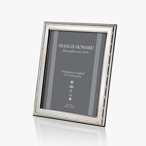 solid sterling silver photo frame with a ribbon design and wooden back with a box