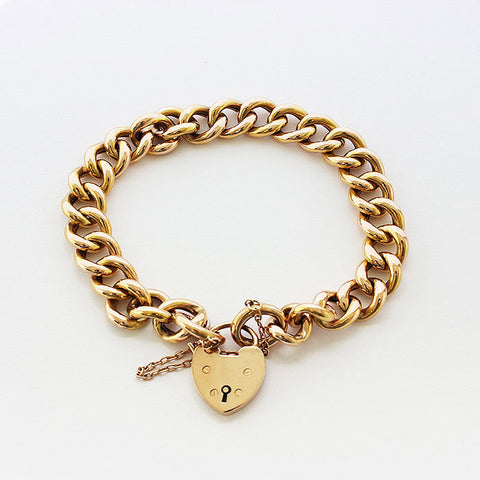 a beautiful secondhand 15 carat yellow gold charm bracelet and padlock