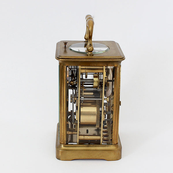 mechanical antique carriage clock with a brass case and white dial and 8 day movement