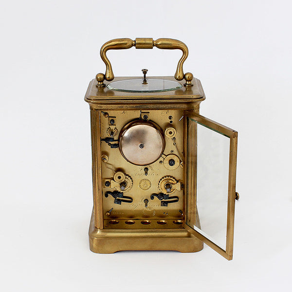 antique carriage clock with brass case and 8 day movement and white dial