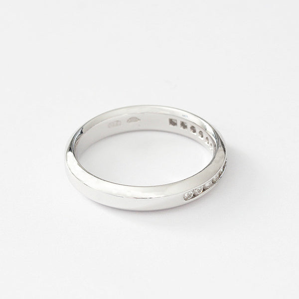 a platinum eternity ring with diamonds in a channel setting