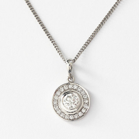 a round diamond cluster pendant on a fine curb link chain 40cm long