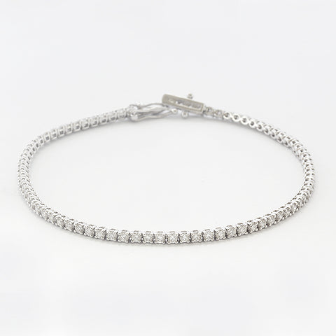 a diamond set tennis bracelet in white gold