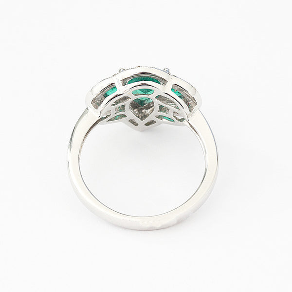 modern emerald and diamond cluster ring in white gold 18ct