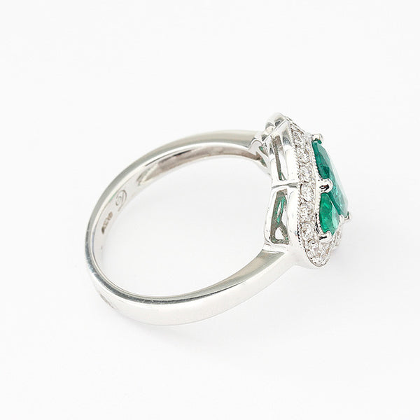white gold emerald and diamond claw set cluster ring
