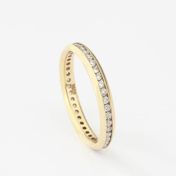 a diamond set full eternity ring in yellow gold with a channel setting