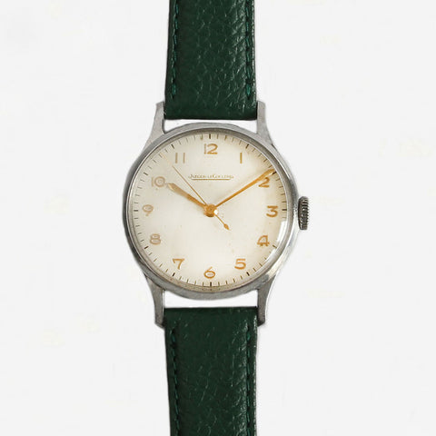 a jaeger le coultre watch with green strap dated 1940s  Edit alt text