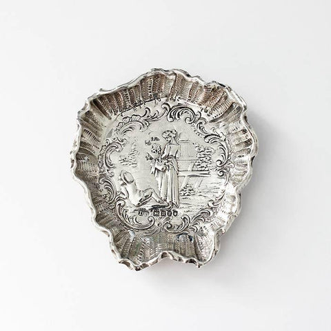 a small silver dish or tray with a pretty scene with a lady and flowers london import mark 1896
