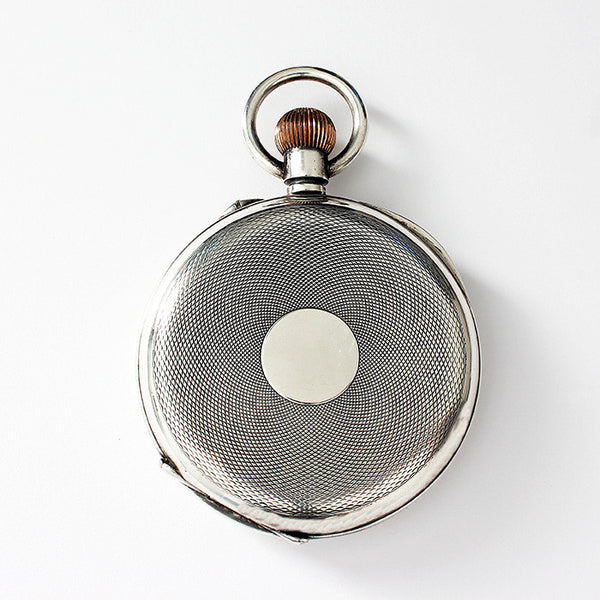 a large secondhand pocket watch in silver and engraving inside