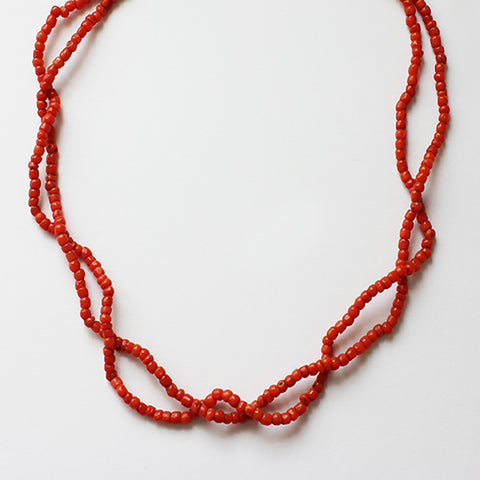 a coral double strand bead necklace with bolt ring clasp