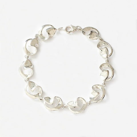 a sterling silver bracelet with openwork swirl design links and a plain trigger clasp