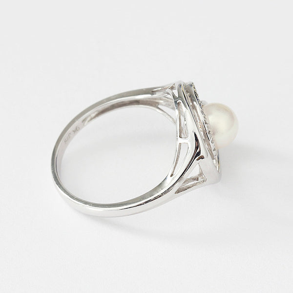 white gold pearl and diamond swirl design ring central pearl