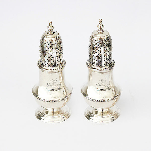 a silver pair of peppers dated london 1749 and with a roped edge