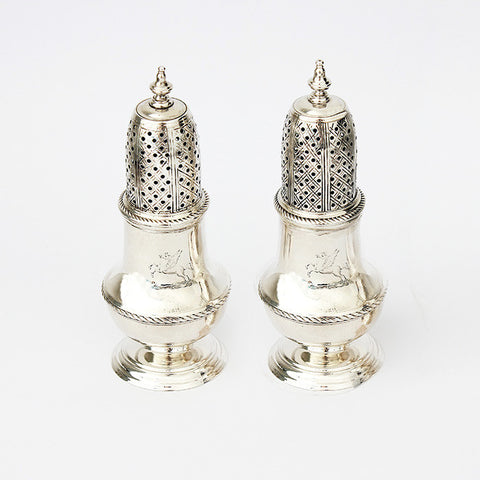 a silver pair of peppers dated london 1749 and with a roped edge