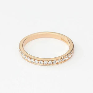 a rose gold three quarter eternity ring with diamonds in a grain setting and finger size M