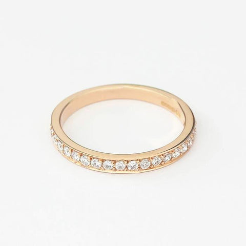 a rose gold three quarter eternity ring with diamonds in a grain setting and finger size M