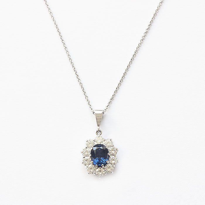 a sapphire diamond oval cluster pendant with trace chain all in white gold