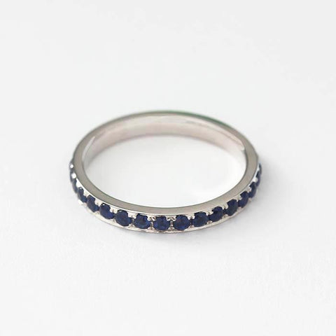 a full eternity ring in 18 carat white gold with 31 round faceted sapphire stones