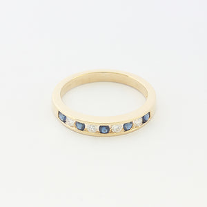 a sapphire and diamond nine stone half eternity ring in yellow gold