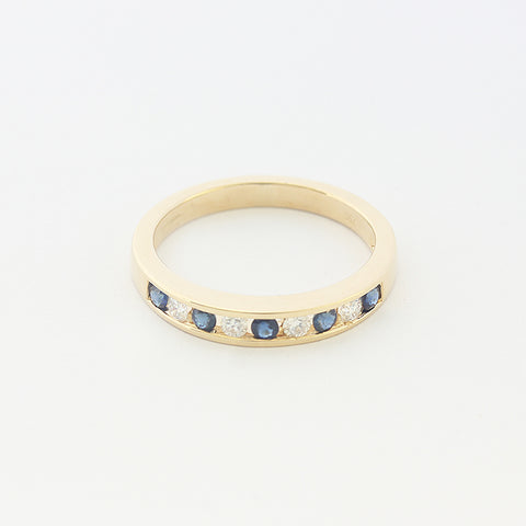 a sapphire and diamond nine stone half eternity ring in yellow gold