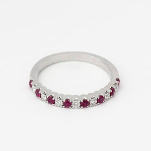 an elegant ruby and diamond half eternity ring in white gold with 8 rubies and 7 diamonds