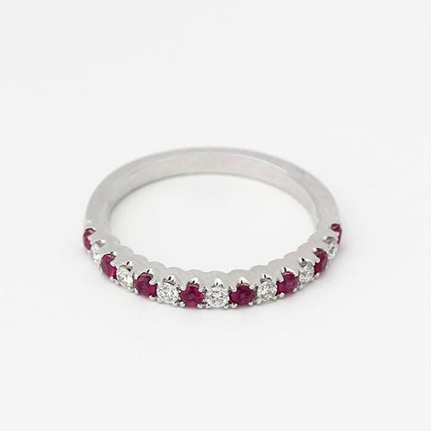 an elegant ruby and diamond half eternity ring in white gold with 8 rubies and 7 diamonds