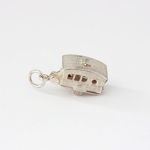 silver opening caravan charm with enamel and furniture inside