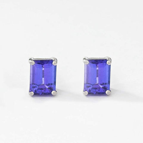 tanzanite stud earrings in 18 carat white gold in an emerald cut shape with a 4 claw setting