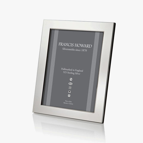sterling silver photo frame made in sheffield with a wide plain finish and black wooden effect on the back